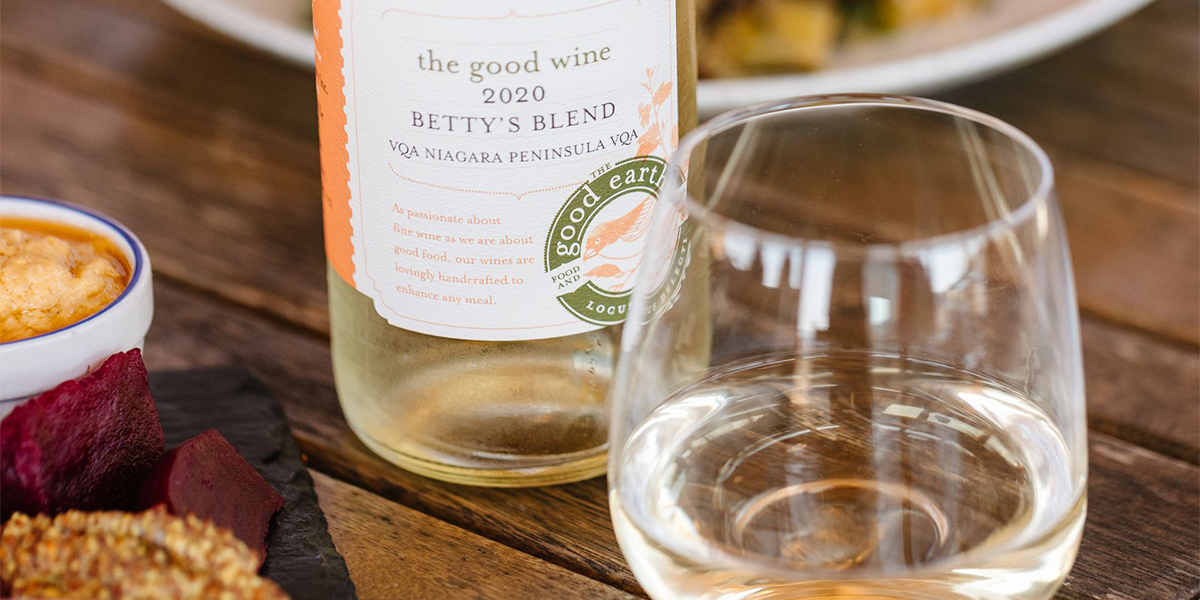 wine-slider bottle of white wine with a glass close up on table